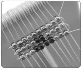 Three rows of beads on a loom